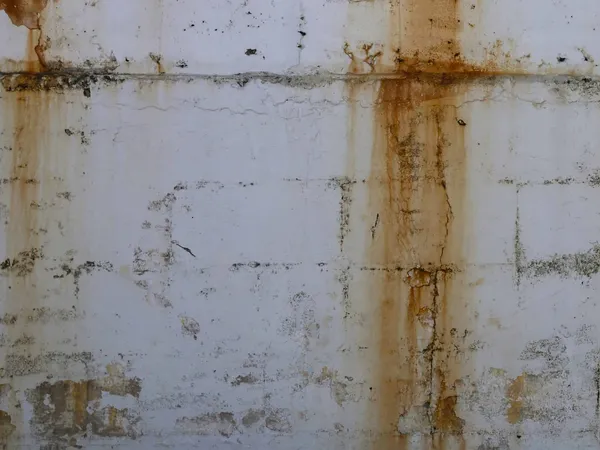 Water stain on a white-painted wall